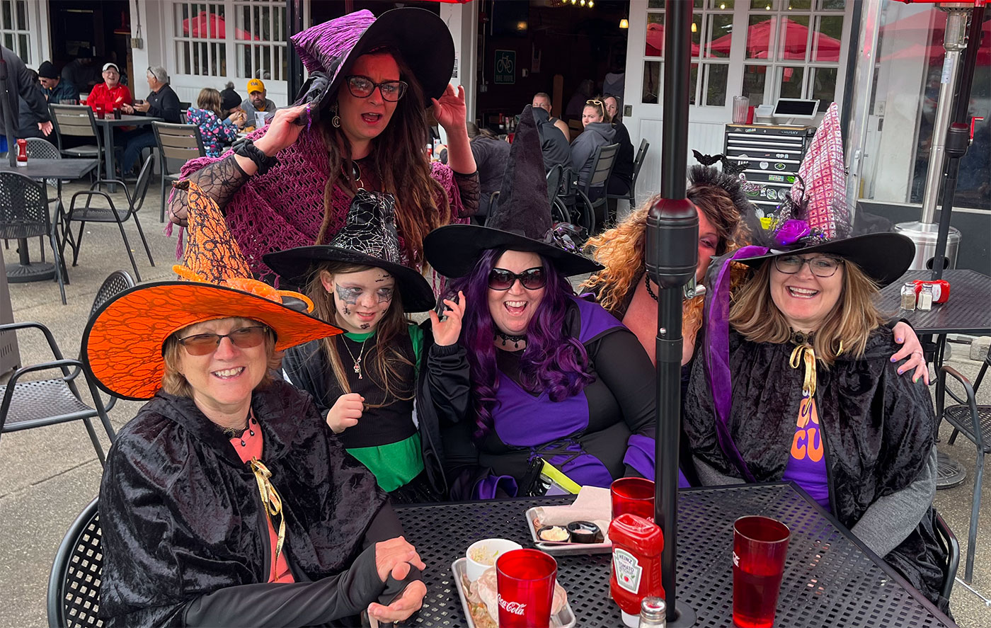 Witches sitting down at the North Park  Boathouse, Saturday, Oct. 7, 2023.